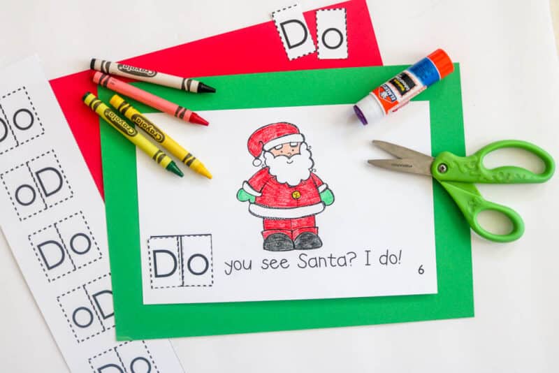 christmas theme kindergarten cut and paste sight word book with crayons, scissors, glue stick and letters to cut and unscramble