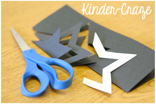 star cut from folded black construction paper with template, scissors and pencil