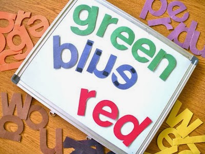 letters cut from colored construction paper stick to small white board with magnets color words spelt include green, blue, and red