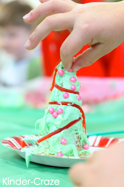 kindergartener pressing shimmery pink candy into green frosting