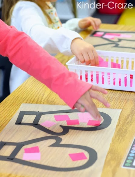 kindergartener adding pink squares contact paper as they make their winter mitten craft