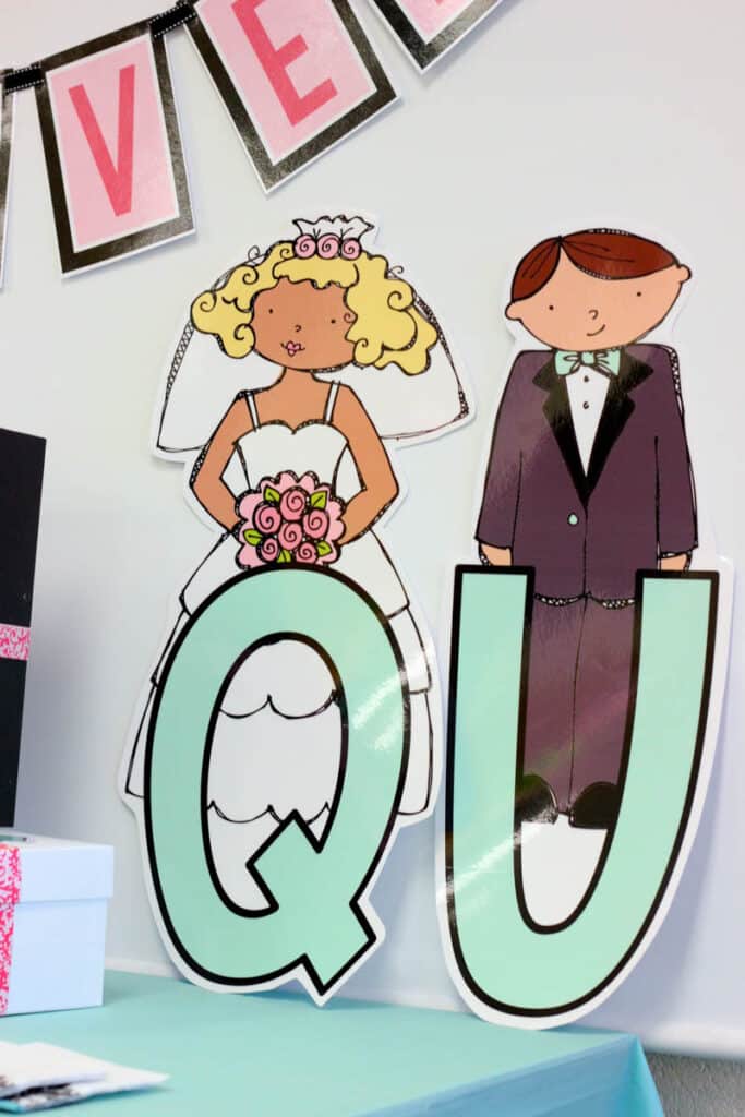 large bride and groom cutouts for a kindergarten Q and U wedding celebration