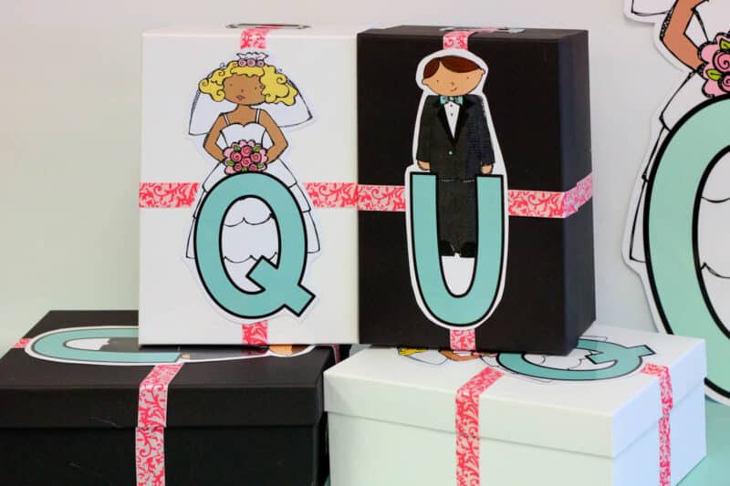 wrapped gifts placed in black and white boxes for a kindergarten Q and U Wedding celebration
