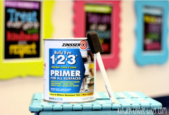 can of primer in a kindergarten classroom used for painting projects with painted picture frames hanging in background
