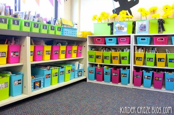 corner of a first grade classroom library organized with black library labels and colorful bins