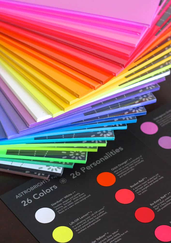 stack of various colors of astrobrights paper fanned out
