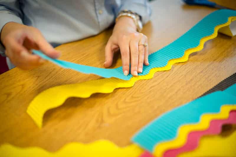 attaching multiple layers of bulletin board borders for a classroom display