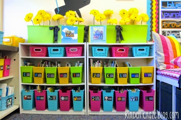 kindergarten classroom library book shelves organized with black library labels on brightly colored book bins