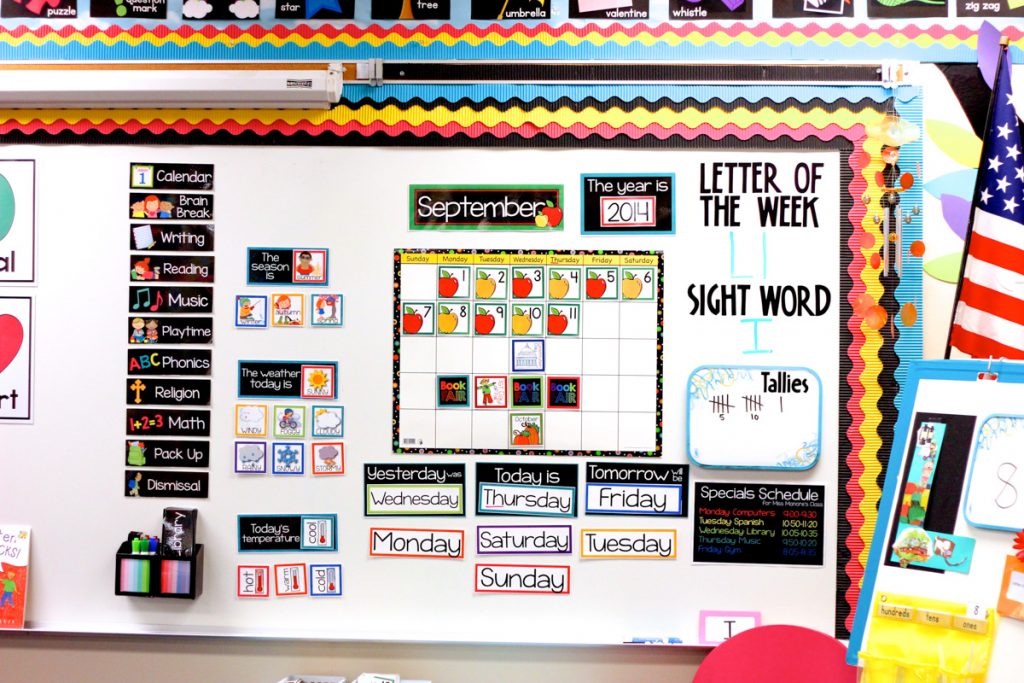kindergarten classroom calendar displayed on a large whiteboard with the date, days of the week, seasons, weather and daily schedule