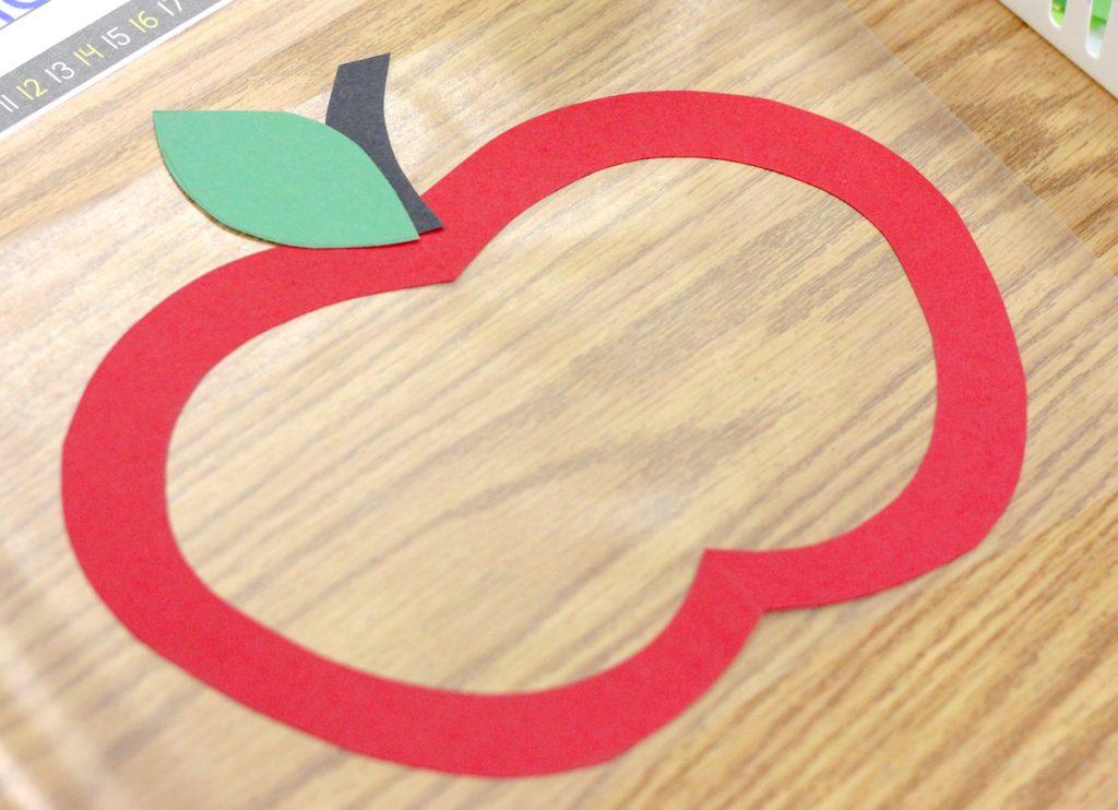 red construction paper apple outline to create stained glass craft