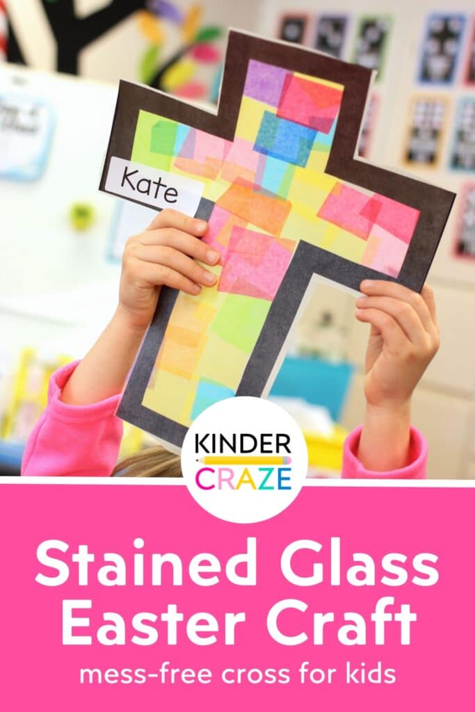 child in classroom holding up a stained glass cross window Lenten craft made with tissue paper and clear contact paper with the words "stained glass easter craft"