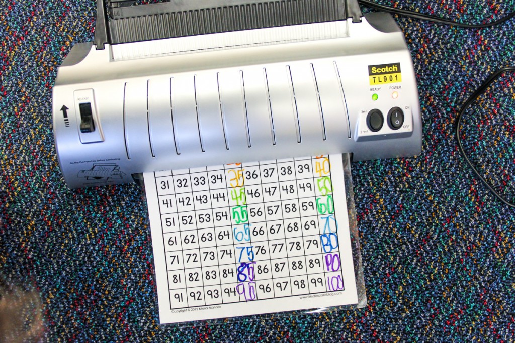scotch laminator being used to laminate student skip counting worksheet