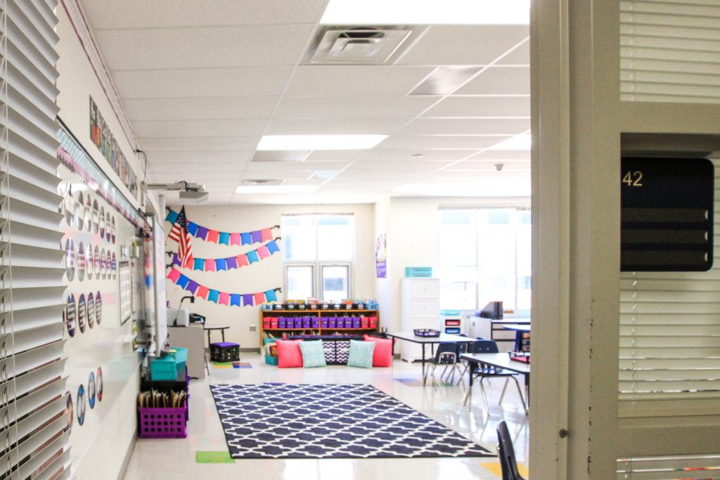 view from the door into first grade classroom with black, white, pink and purple classroom decor