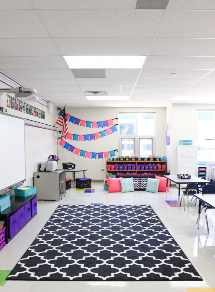first grade classroom library area with large black and white rug for students