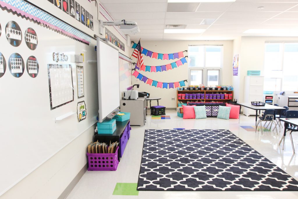 first grade classroom circle area with large black and white rug near classroom library