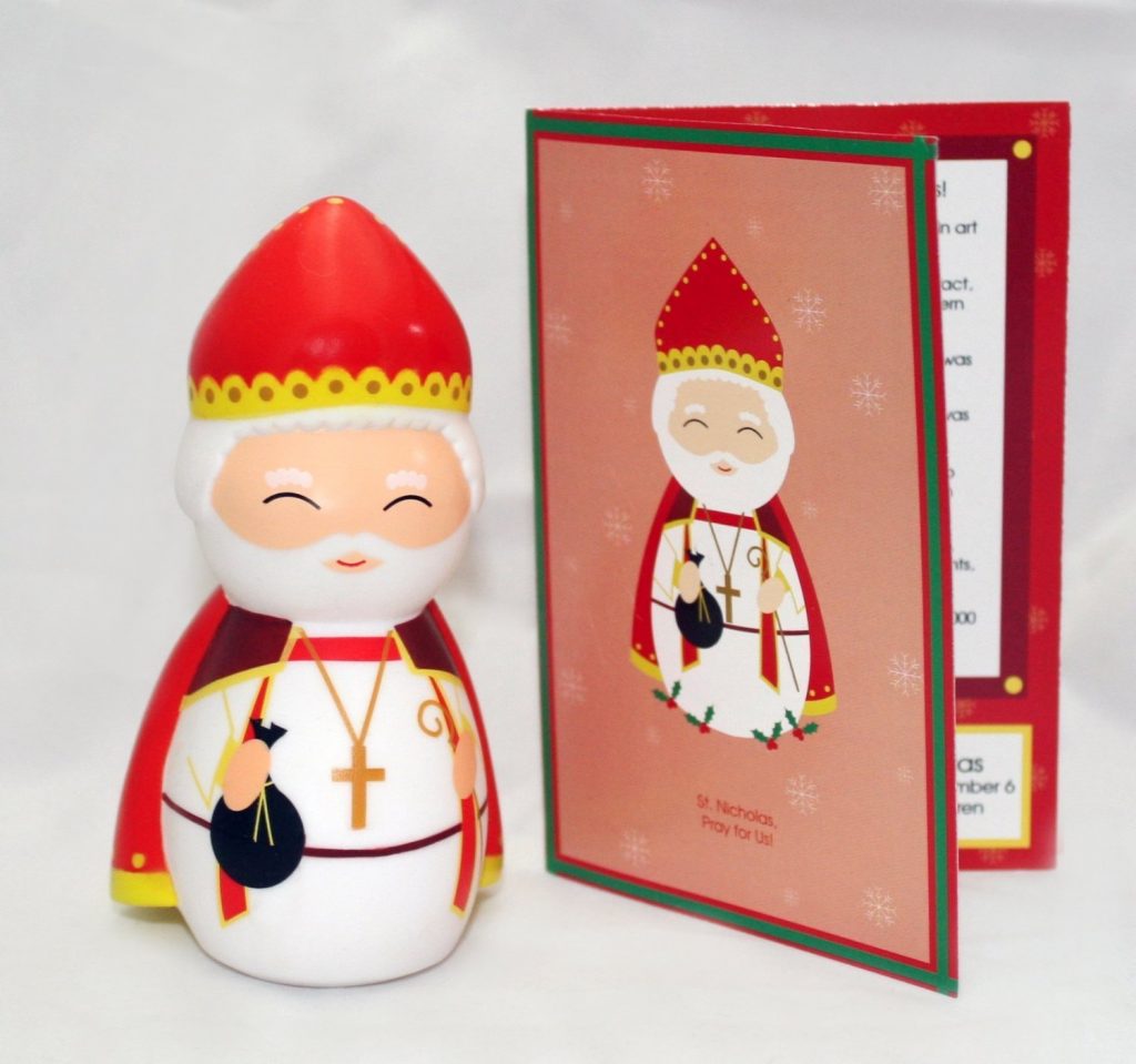 Adorable St. Nicholas shining light doll for kids stands next to Saint Nicholas information card