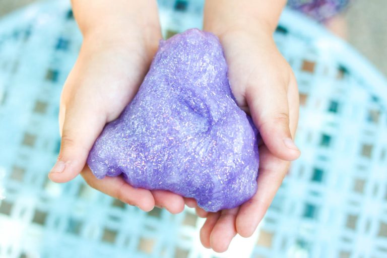 child holding glitter slime made at home from recipe