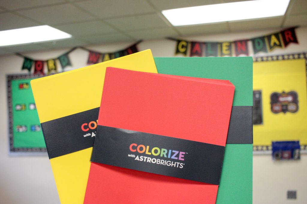 red, green and yellow sheets of astrobrights paper in apple-themed first grade classroom