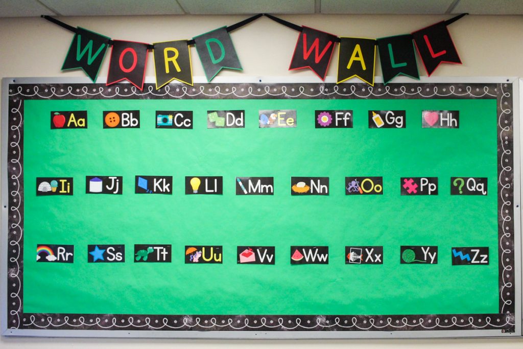 classroom bulletin board with pennant letters across the top that say "word wall"