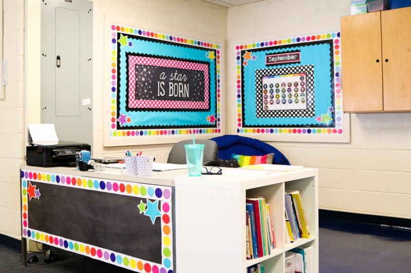 teacher desk area with cute bulletin board and clutter-free desk